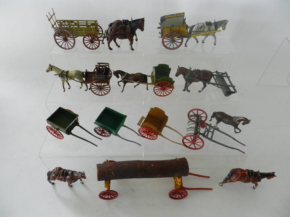 A group of 10 horse drawn carts and implements in lead by Britains, Charbens and others.