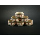 A set of six Indian stained ivory napkin rings, worked with stylised flower borders, 5cm diameter.