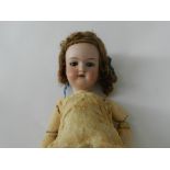 An Armand Marseille bisque headed doll with open mouth revealing 2 upper teeth and brown sleeping