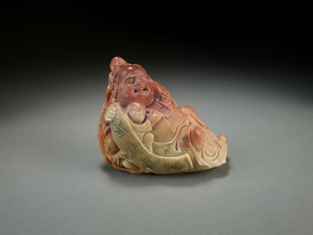 A Chinese carved soapstone figure of a laughing Buddha, 20th Century,