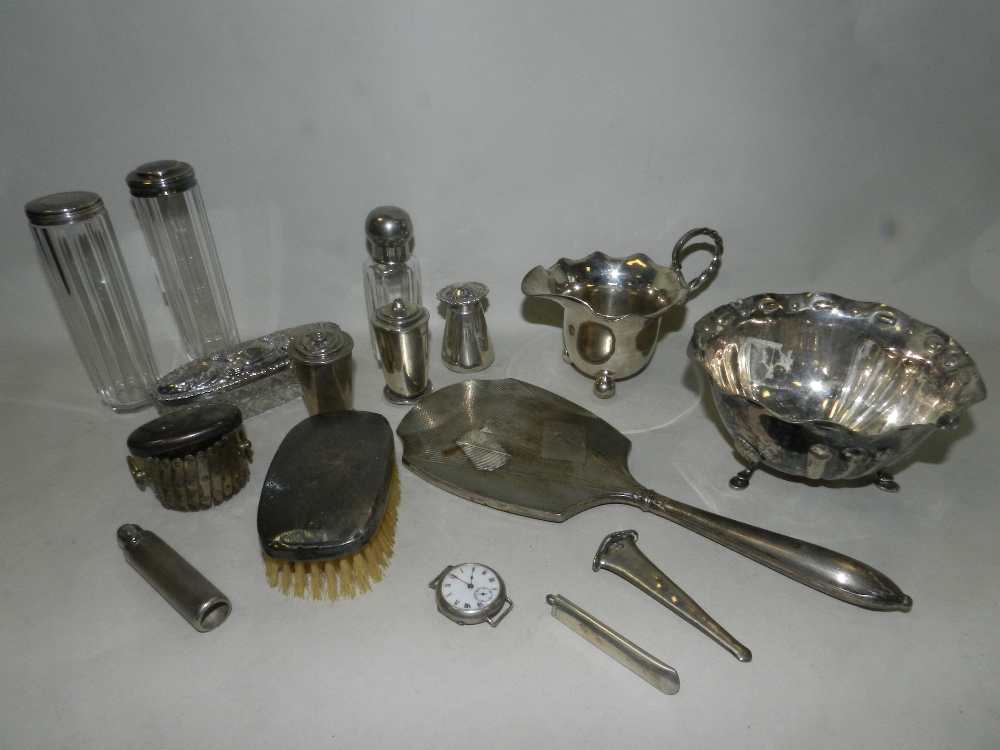 A collection of various silver mounted hair and clothes brushes, a collection of silver pepperettes,