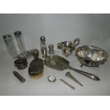 A collection of various silver mounted hair and clothes brushes, a collection of silver pepperettes,
