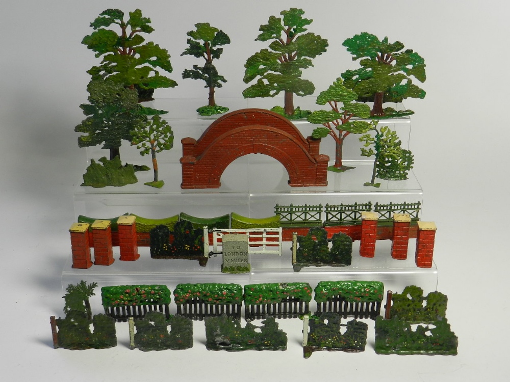 A collection of lead accessories by Britains and other makers to include trees, fencing, bridge,