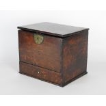 An early 19th century oak candle box the hinged lid over a short drawer to the base,