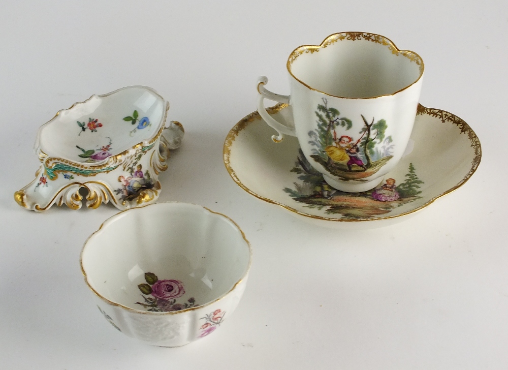 A Meissen quatrefoil cup and saucer decorated with scenes of lovers frolicking within landscapes,