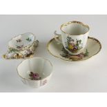A Meissen quatrefoil cup and saucer decorated with scenes of lovers frolicking within landscapes,