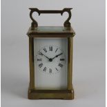 An early 20th century French gilt brass carriage clock the 2 inch white enamel dial with ring of