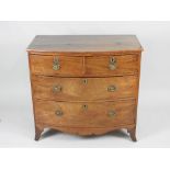 A small Regency bowfront mahogany chest of two short over two long graduated drawers fitted with