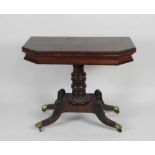 A 19th century American mahogany fold over tea table with canted angles the swivel top revealing a