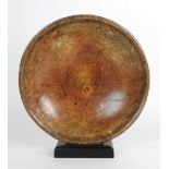 An early 19th century shallow sycamore bowl, with triple line rim decoration, 42cm diameter,