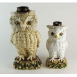 Two late 19th century Continental porcelain table lamp bases in the form of owls with glass eyes,