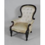 A Victorian walnut spoon back enclosed armchair with scroll moulded front arm supports raised on