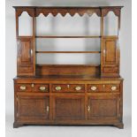 A George III oak Shropshire style high dresser with open three shelf rack flanked by a single