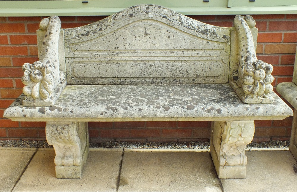 A pair of reconstituted stone garden benches,