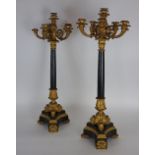 A pair of Charles X ormolu mounted black marble six light candelabra each on triangular shaped