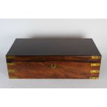 A mid 19th century teak campaign style lap desk, with inset brass corner protectors and handles,