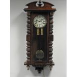 A late 19th century walnut Vienna style twin weight driven wall clock with 7 inch enamel dial with
