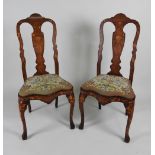 A pair of 19th century Dutch walnut and marquetry dining chairs each with a serpentine top rail and