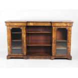 A mid Victorian figured walnut and marquetry inverted break front low bookcase the open central