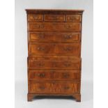 An early 18th century walnut crossbanded chest on chest the top section of three short over three