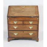 A mid 18th century oak fall front bureau the fall revealing a well fitted interior of short drawers