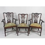 A set of twelve mahogany Chippendale style dining chairs including two carvers each with a pierced