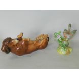 A Karl Ens Volkstedt porcelain figure of a recumbent dachshund with a Crown Staffordshire model of