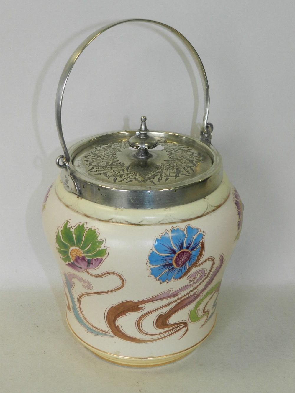 A Carlton Ware biscuit barrel with white metal cover and swing handle