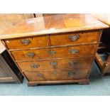 A William and Mary and later walnut veneered chest of two short over three long graduated drawers