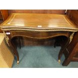 A reproduction mahogany and brass inlaid fold-over games table.