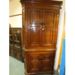 A George III oak standing corner cupboard the cavetto cornice above twin sets of panelled doors