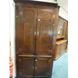A late George III oak crossbanded mahogany floor standing straight fronted full height corner