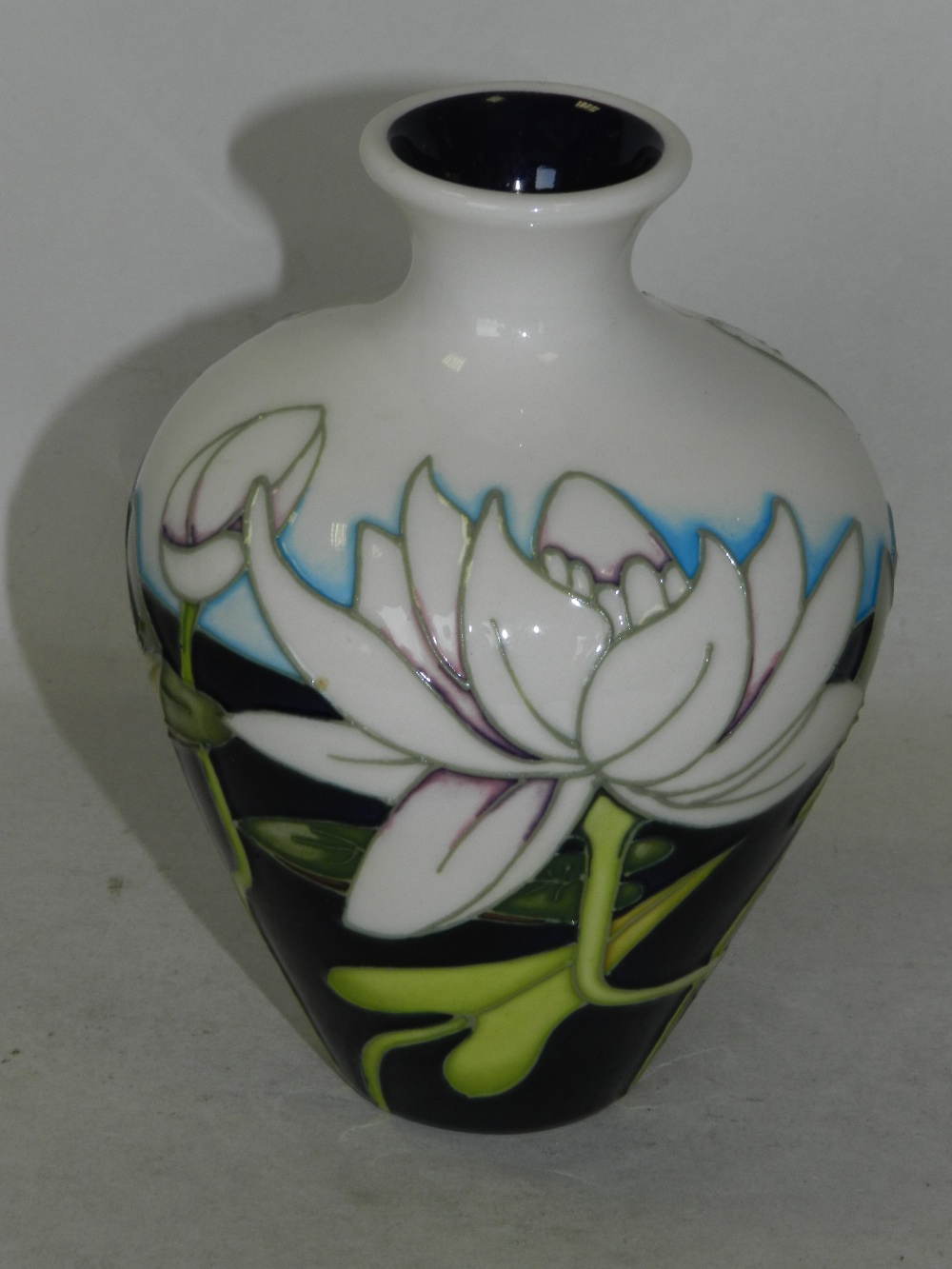 A small contemporary Moorcroft vase tubelined with flowers contained within original box