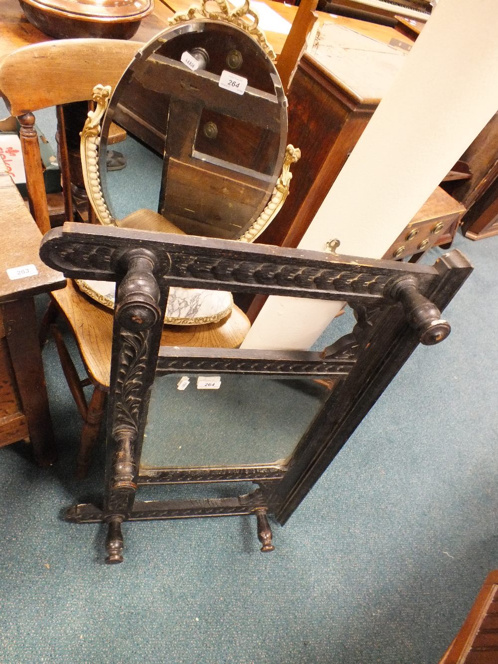 An ebonised oak hall mirror with turned coat hooks together with an Edwardian spindle back kitchen