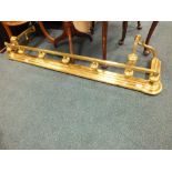 A 19th/early 20th century brass fire curb.