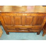 A mid 18th century oak coffer the two plank lid over seven fielded panels to the front,