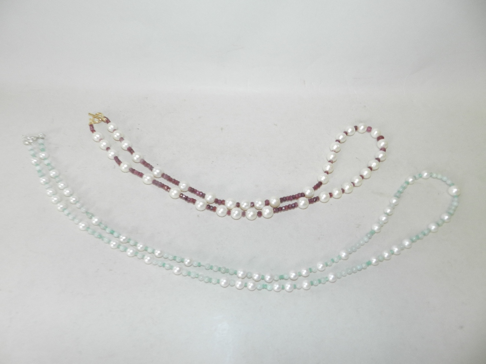 A cultured pearl and ruby necklace together with a cultured pearl, emerald and jadite necklace.