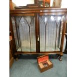 An early 20th century bow front china display cabinet along with a faux rosewood grained two
