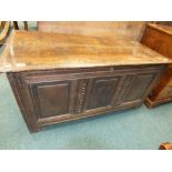 A 19th century oak panelled coffer the moulded top opening to a plain interior, lacking candle box,