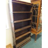 A Globe Wernicke, a five tier open bookcase raised on a single drawer base.