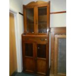 An Edwardian walnut glazed two tier bookcase cabinet.