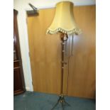 A copper and brass adjustable standard lamp.