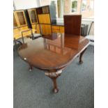 An Edwardian mahogany wind out dining table,