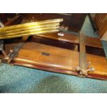 A Lewis' Ltd table top trouser press together with a set of brass stair rods.