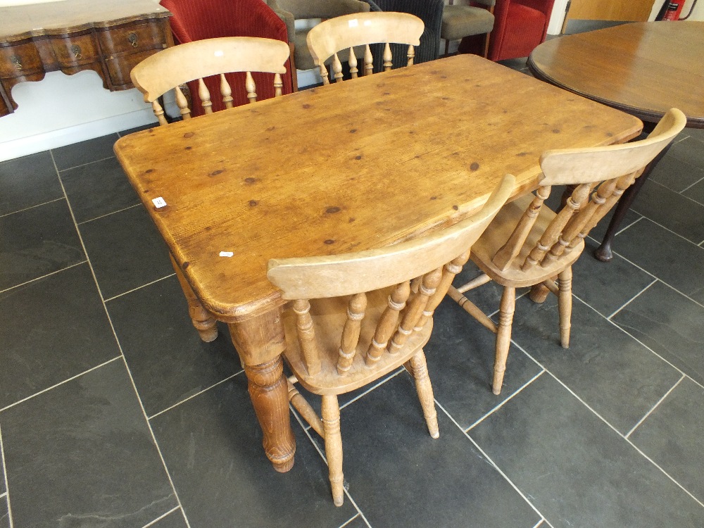 A reproduction pine kitchen table with twin end drawers together with a set of four beech dining