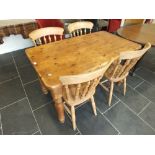 A reproduction pine kitchen table with twin end drawers together with a set of four beech dining