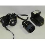 A Nikon EM 35mm SLR camera with Canon Speedlite,