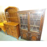 An early 20th century oak dresser with arched top rack,
