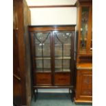 An Edwardian inlaid mahogany glazed display cabinet.