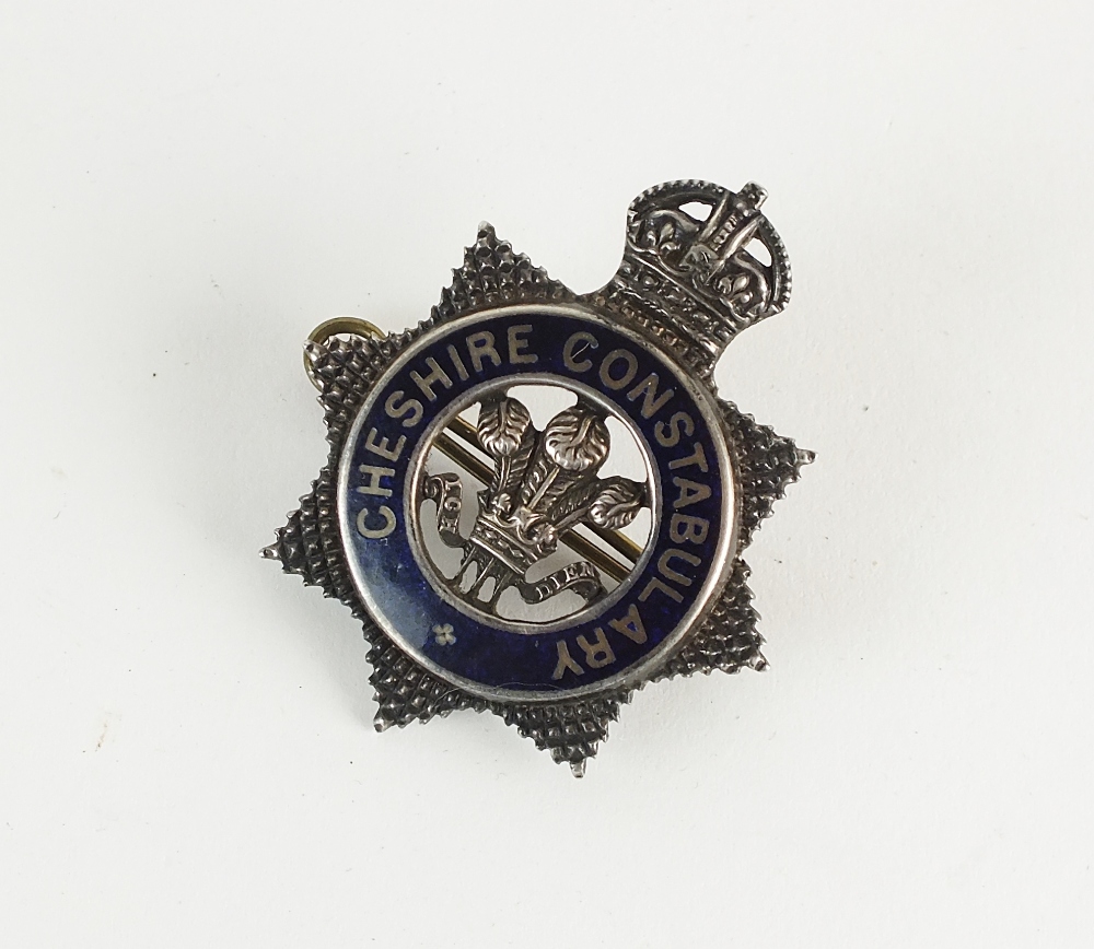 A King's crown white metal and blue enamel Cheshire constabulary badge, stamped 'Sterling Silver',